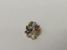 18ct gold floral brooch with blue, green & red stones & diamonds. Estimate £50-70.