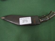 Kukri knives in leather scabbard. Estimate £20-30.