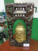 Oriental brass bell in ornately carved stand (temple bell), height 45cms. Estimate £50-100.