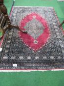 Red ground Pakistan hard-knotted carpet, 196 x 137. Estimate £60-80.