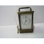 Brass cased carriage clock with visible escapement c/w key. Estimate £40-60.