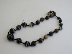 Banded agate necklace, length 44cms. Estimate £200-250.