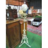 White painted wrought iron stand with oil lamp & glass shade. Estimate £20-30.