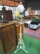 White painted wrought iron stand with oil lamp & glass shade. Estimate £20-30.