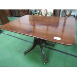 Regency mahogany tilt-top breakfast table on pedestal to 4 legs on brass castors, 121cms x 85cms x