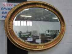 Pair of highly ornate oval gilt framed bevel edged wall mirrors, 66cms x 86cms. Estimate £60-80.