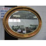 Pair of highly ornate oval gilt framed bevel edged wall mirrors, 66cms x 86cms. Estimate £60-80.