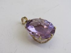 Large chequer board cut amethyst pendant bound in 14ct gold, 2.5cms x 2cms, weight 8.6gms.