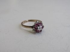 9ct gold, red stone & diamond cluster ring, size R, weight 2.5gms. Estimate £30-50.
