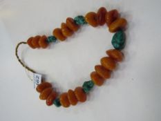 String of Butterscotch, amber, Bakelite celluloid prayer beads as a necklace interspersed with