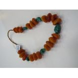 String of Butterscotch, amber, Bakelite celluloid prayer beads as a necklace interspersed with