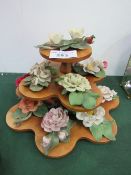 Set of 11 porcelain roses & display stand. Estimate £10-20.