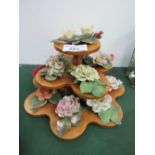 Set of 11 porcelain roses & display stand. Estimate £10-20.