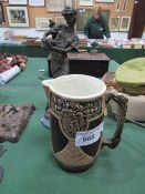 Large brown pottery jug & a copper coloured resin figure of a lady & a dog. Estimate £10