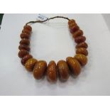 Very large string of graduated honey, amber, Bakelite, cellulite prayer bead necklace. Weight