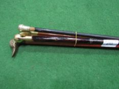 4 walking sticks, 1 with hidden flask, 1 with silver top & 2 with duck heads. Estimate £15-20.