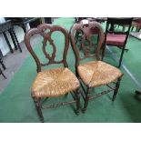 Pair of 1860/1890 walnut dining chairs with carved splat backs. Estimate £30-50.