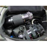 Canvas bag containing Soligor lens, Canon lens & qty of filters. Estimate £30-50.