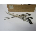 23 PE800 silver handled decorated skewers, length 20cms, weight 9.7ozt. Estimate £50-80.