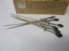 23 PE800 silver handled decorated skewers, length 20cms, weight 9.7ozt. Estimate £50-80.