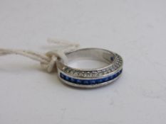 Marked 10 carat white gold, tanzanite & white stone half eternity ring, size P, weight 4.1gms.