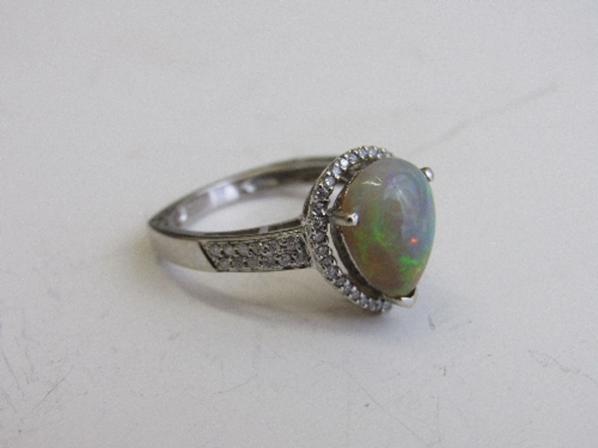 18ct white gold, diamond & pear shaped opal rings, size N. Estimate £850-1,000.