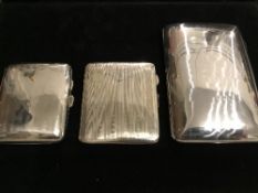 3 sterling silver cigarette cases: by J W Banks, 1894, 5ozt, by Thomas Bigham, 1918, 2ozt & by C H