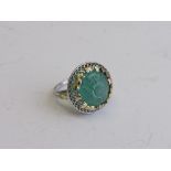 Tested 14ct white gold ring with Arts & Crafts gold leaf work on natural mogul carved emerald.