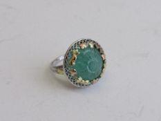 Tested 14ct white gold ring with Arts & Crafts gold leaf work on natural mogul carved emerald.