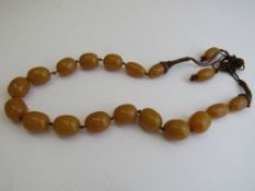 Amber beaded necklace, overall length 100cms. Estimate £250-350.