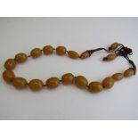 Amber beaded necklace, overall length 100cms. Estimate £250-350.