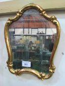 Shaped gilt framed wall mirror. Estimate £10-20.