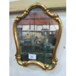 Shaped gilt framed wall mirror. Estimate £10-20.