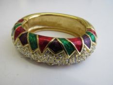 Swarovski clear stone & enamels on gold coloured bracelet. Estimate £40-60.