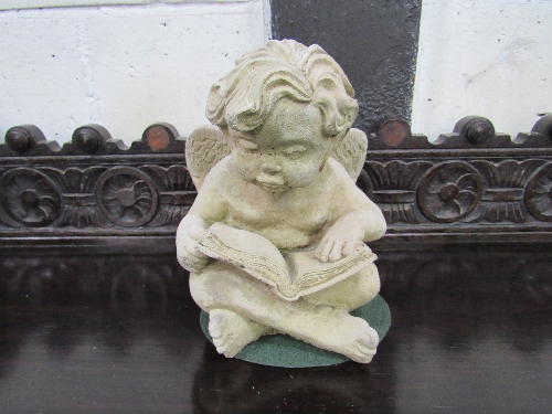 Moulded stone-like Putto with book. Estimate £20-30.