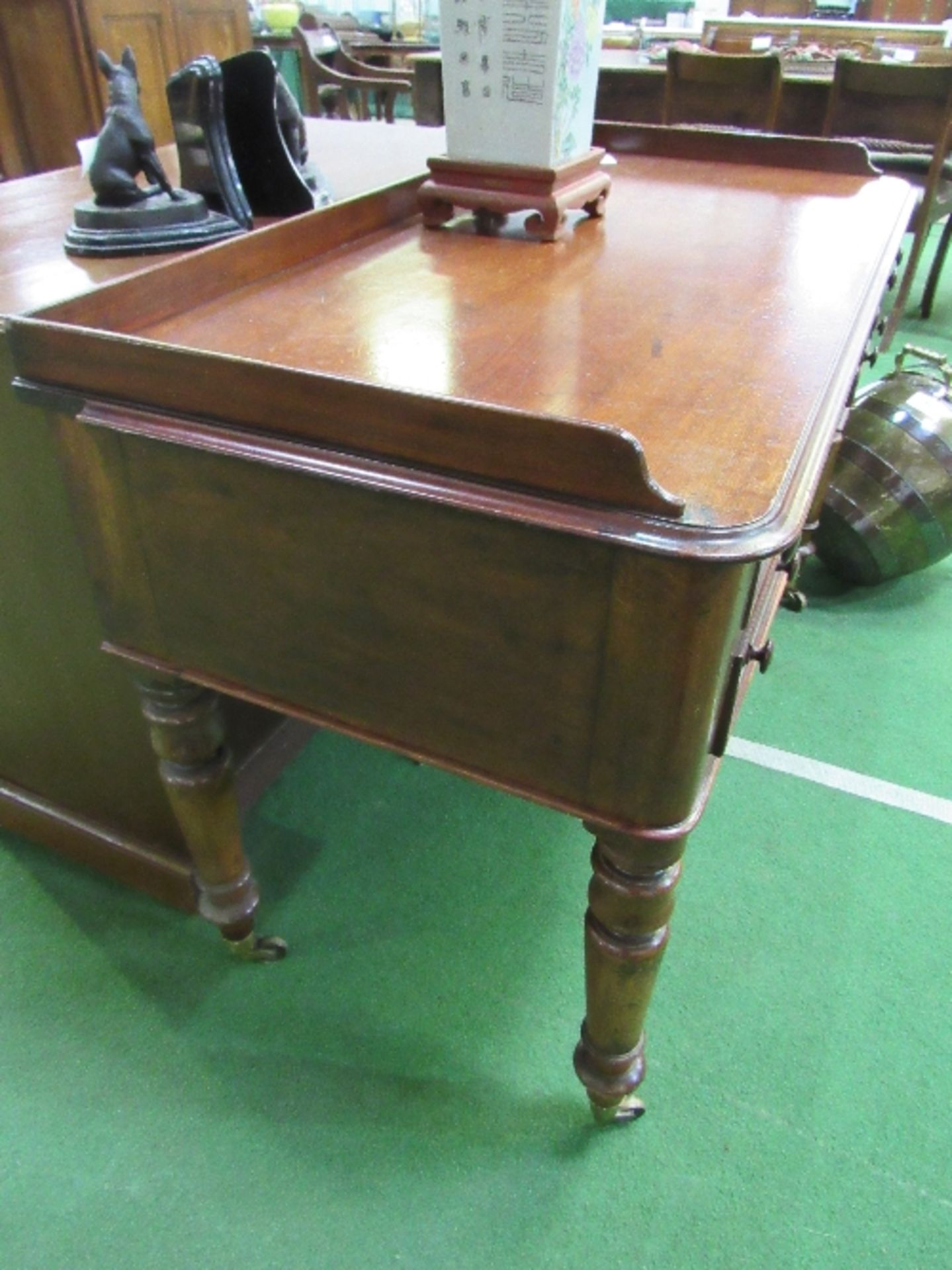 Mahogany writing desk on turned legs to casters, 122cms x 57cms x 77cms. Estimate £80-100. - Image 3 of 4