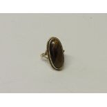 Tested 9ct gold large oval tiger's eye ring, weight 5.5gms. Estimate £70-80.