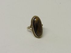 Tested 9ct gold large oval tiger's eye ring, weight 5.5gms. Estimate £70-80.