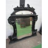 Ebonised ornate over mantle mirror with shaped sides, 130cms x 124cms. Estimate £30-50.