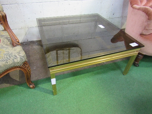 Gold coloured metal coffee table with smoked glass top by Pierre Vandel, Paris. Estimate £50-100.