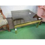 Gold coloured metal coffee table with smoked glass top by Pierre Vandel, Paris. Estimate £50-100.
