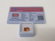 Natural emerald cut orange loose sapphire, 6.35 carat, with certificate. Estimate £50-70.