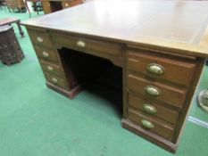 Large Partners' oak desk with leather skiver, drawers to one side & cupboards to the other end