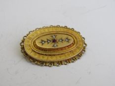 9ct gold, ruby & seed pearl brooch, weight 5.9gms, length 3.5cms. Estimate £110-130.