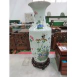 Large oriental vase on wooden stand, height 66cms. Estimate £100-150.