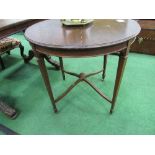 Circular mahogany table on tapered legs to castors, 76cms diameter. Estimate £10-20.