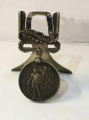 A Crimea War medal 1854 with foliate bar mounted on a silver stand, hallmarked Horton & Allday,