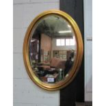 Bevel edge oval gilt framed wall mirror, 80cms x 62cms. Estimate £20-40.