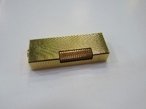 Authentic Dunhill gold coloured rollagas lighter, Swiss made with code RE24153. Estimate £40-60.