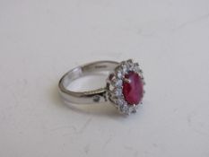 18ct white gold, ruby & diamond cluster ring, size L, 5.2gms. Estimate £850-1,000.